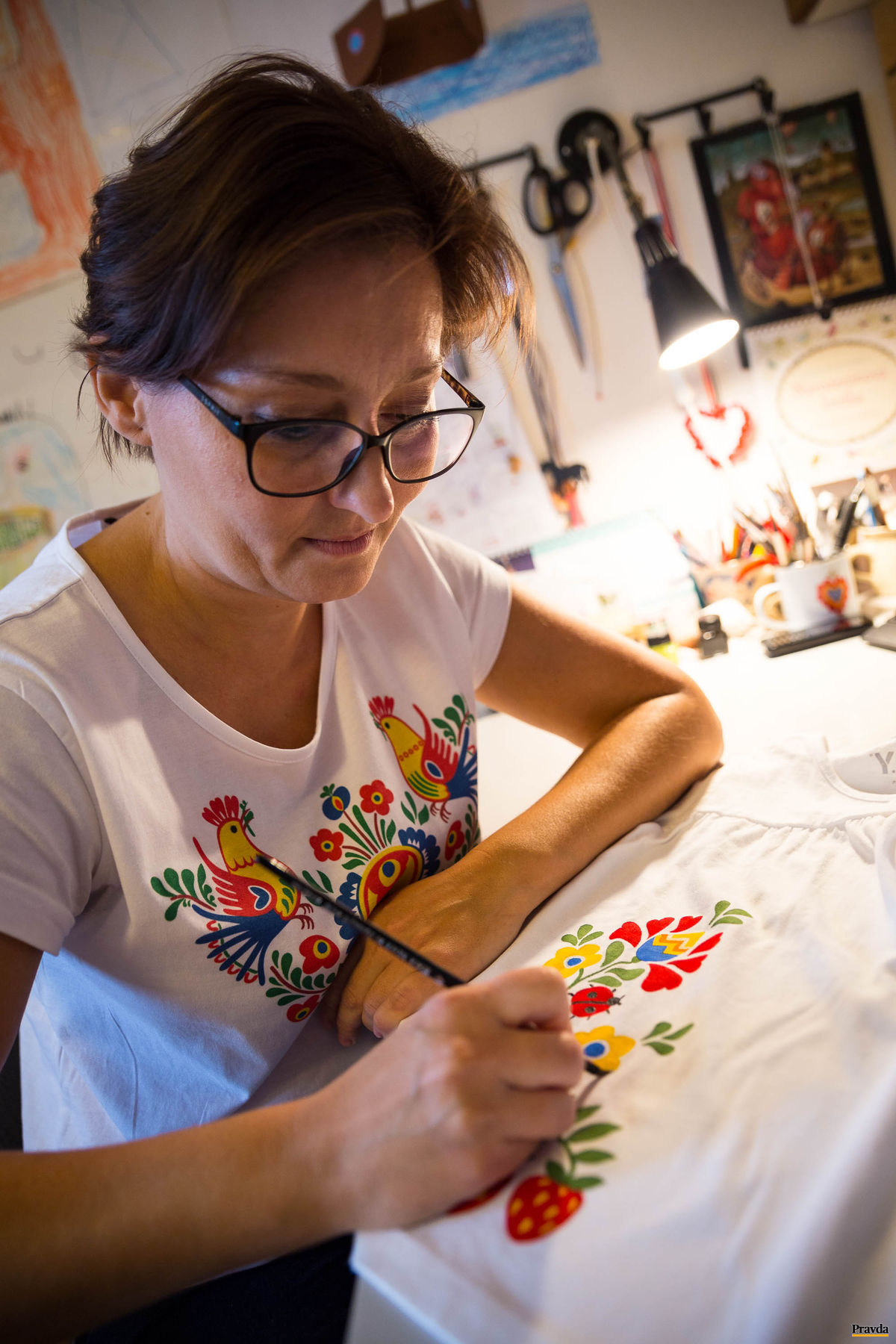 Katarína Šimčíková maľuje na odevy ručne.