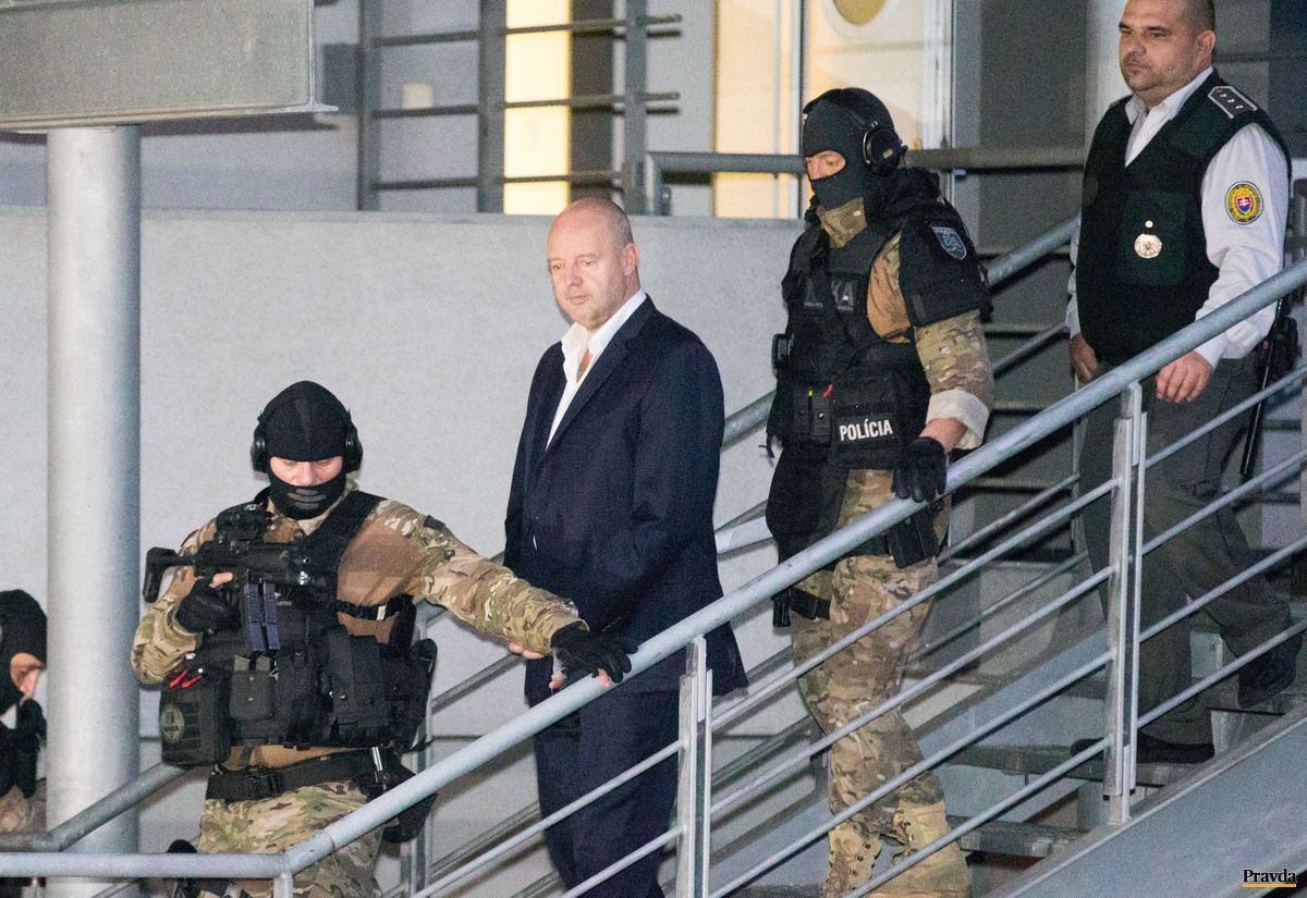 Policajti odvádzajú exriaditeľa televízie...