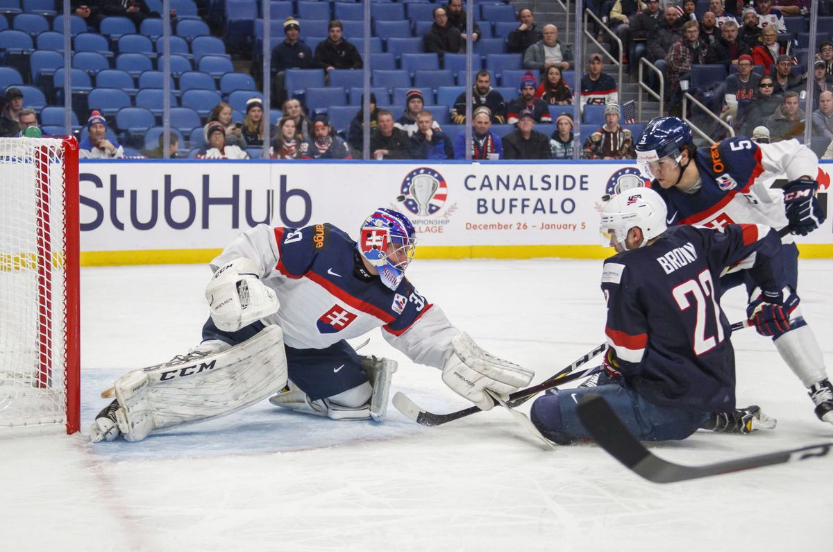 Gólman SR Roman Ďurný zasahuje pred americkým...