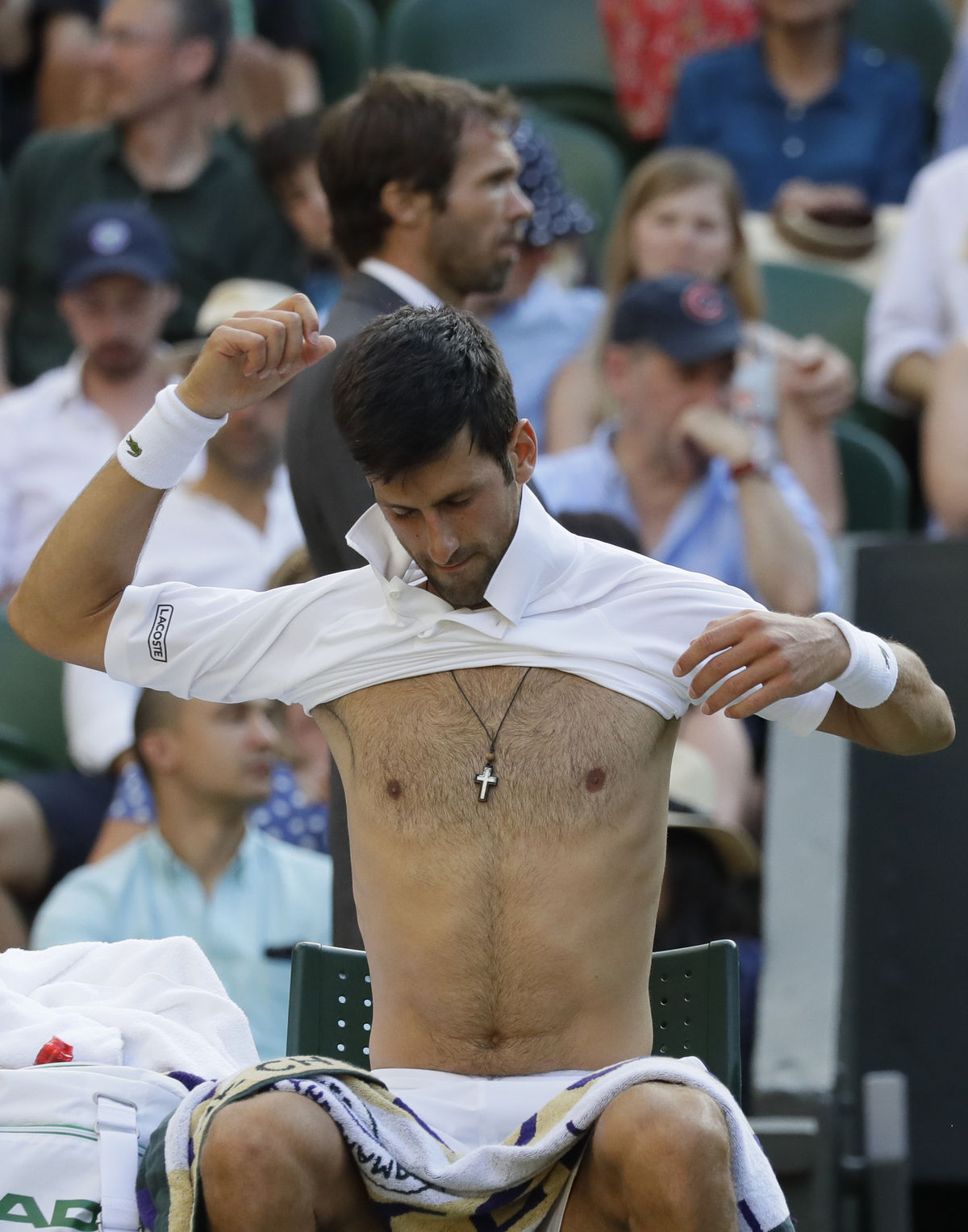 Srbský kráč Novak Djokovič si prezlieka tričko...