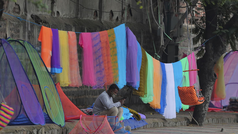 Indický predajca sietí proti komárom s rúškom....