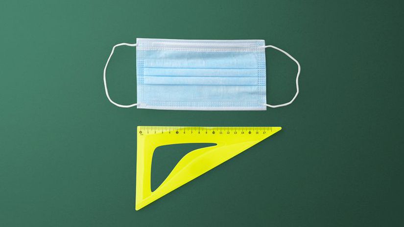 Flat lay top view of face mask and ruler, back...