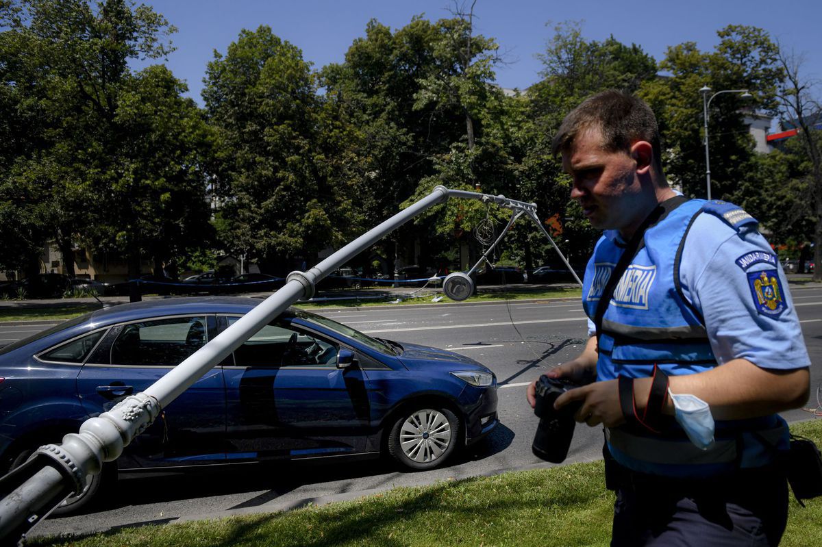Policajt kontroluje auto a stĺp verejného...