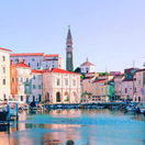 Piran. 09.08.2020. Scenic view of the town of Piran with the main square of Tartini, old colorful buildings with red roofs and the Adriatic Sea with yachts in the coast of Slovenia. Travel concept