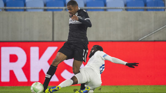 Pictured left Lucas Taylor (Paok) and Rabiu ...
