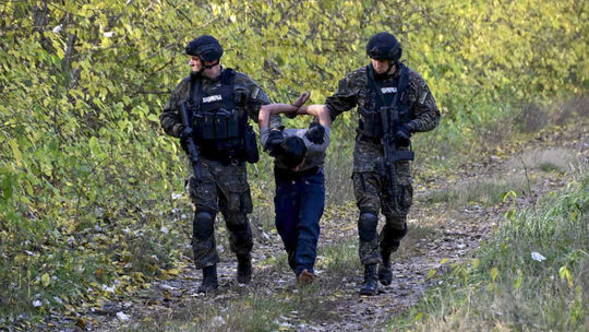 Príslušníci srbskej polície odvádzajú...