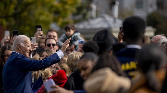 US President Joe Biden greets...