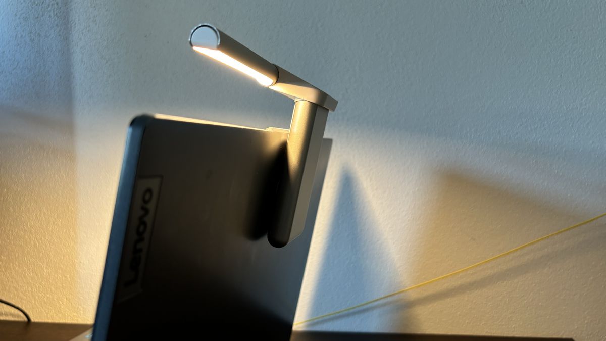 The lamp is attached to the laptop using a magnet and...