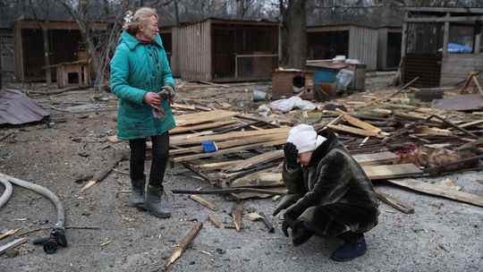 Ľudia pozorujú skazu po ruskom leteckom útoku,...