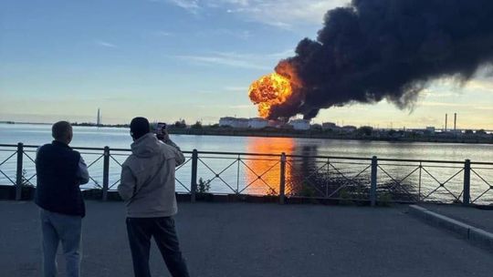 A column of black smoke over the port of St. Petersburg in...